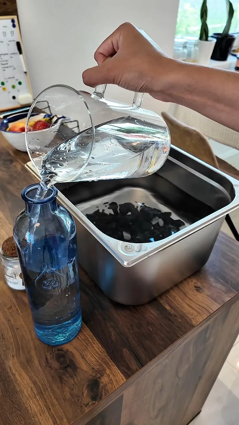 Filtered water poured into a clear glass at the tap